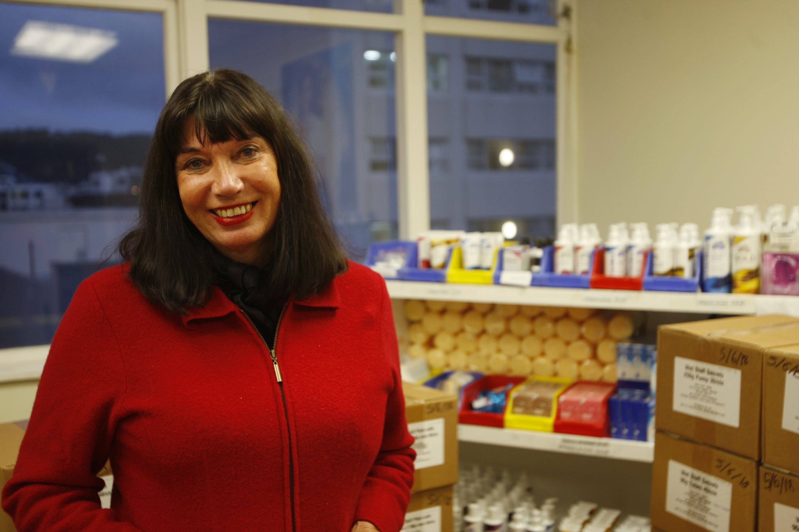 Catherine Healy, the national coordinator of the New Zealand Prostitutes' Collective, stands in front of supplies at the collective's office in Wellington, New Zealand.