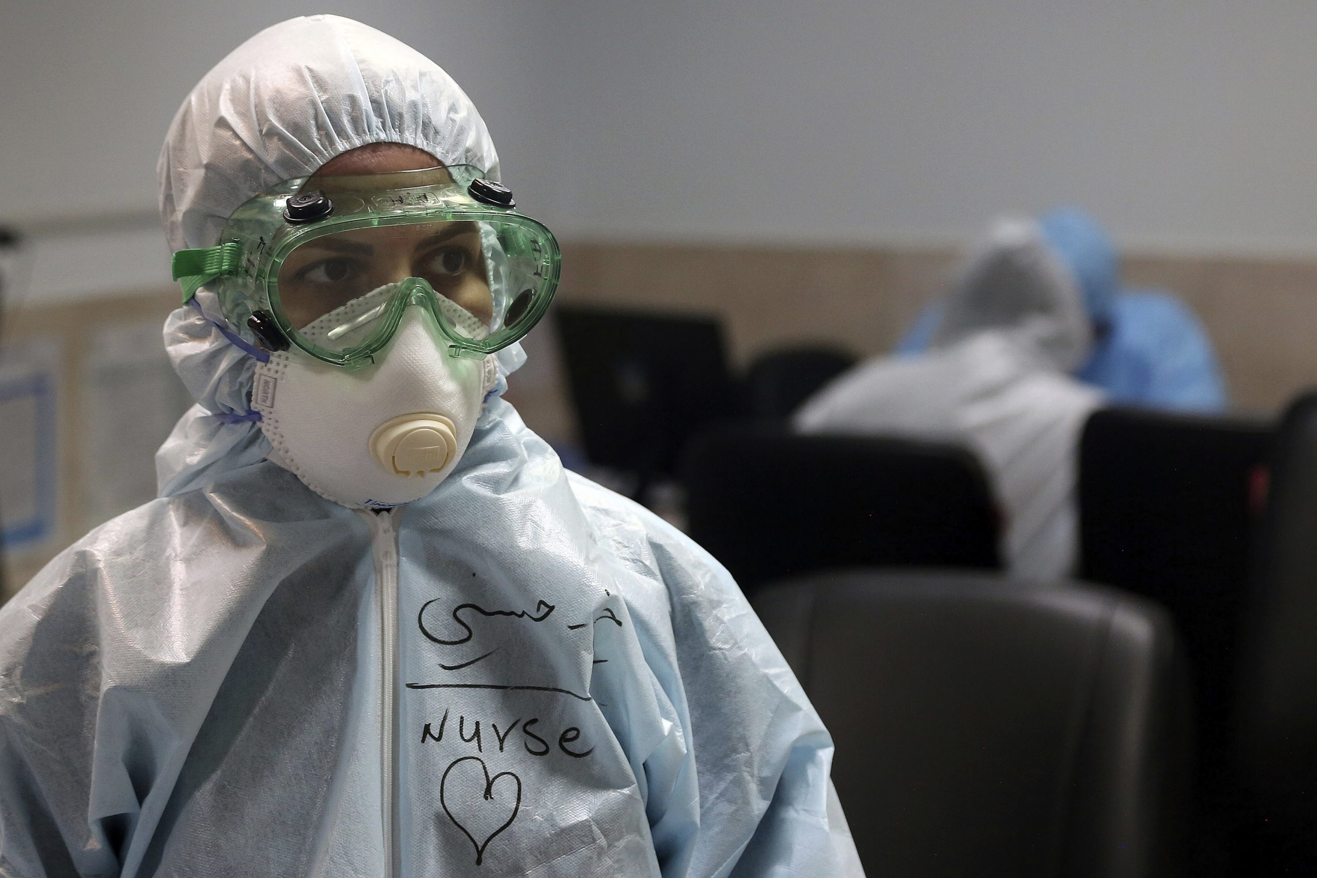 A nurse wearing full protective gear in a hospital