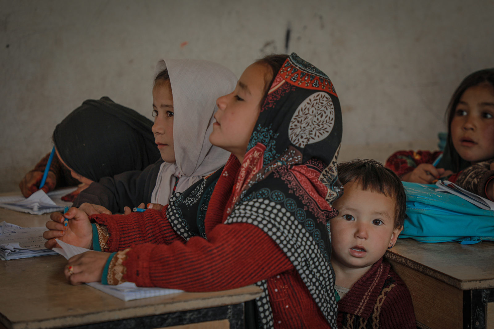 A photo of school girls with headscarves in a classroom