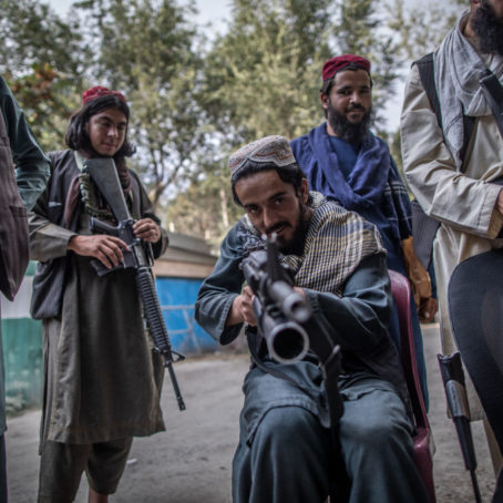 A photo of a Taliban fighter aiming his gun at the photographer