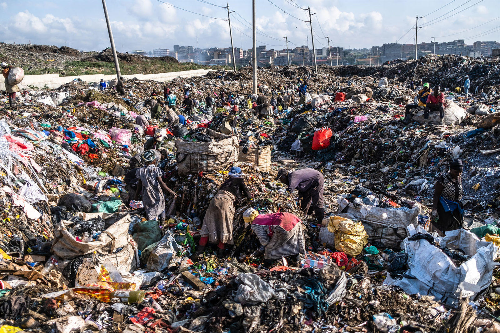 A photo of people sorting trash at a dumpsite