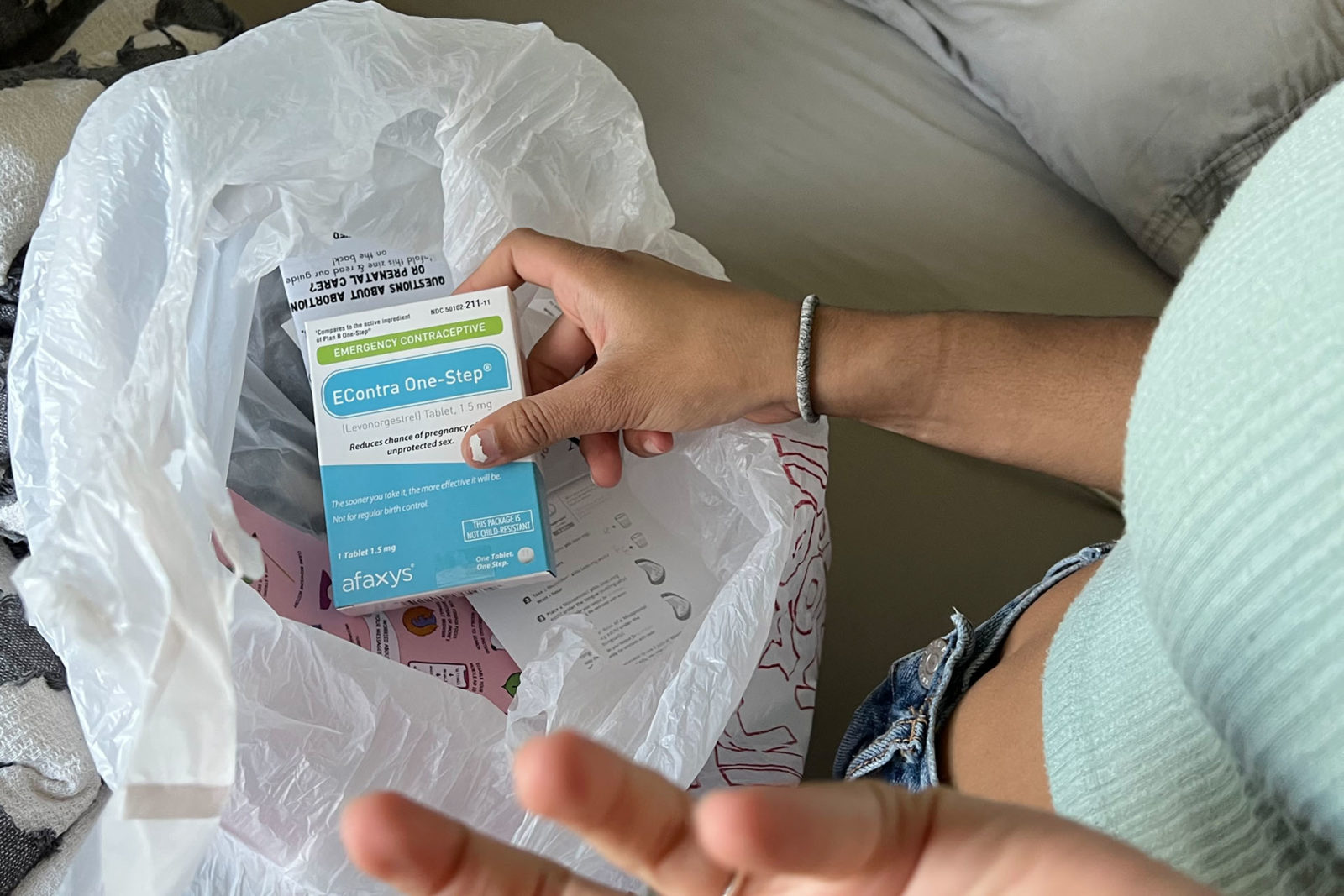 A photo of a person holding a box of emergency contraceptives
