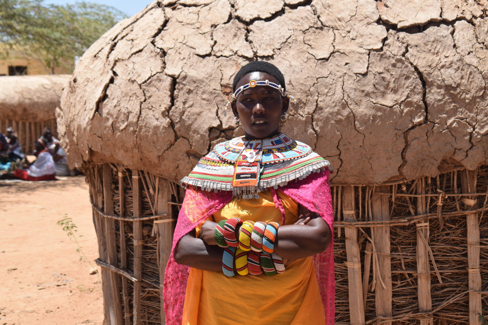 A woman stands outside her mud-walled hut at the Umoja Village women's refuge in northern Kenya.