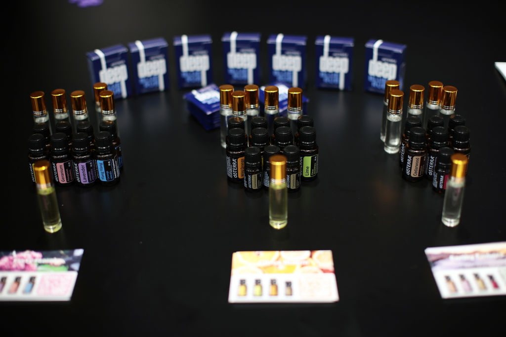 Bottles of doTERRA's essential oils sit on a table for display. 