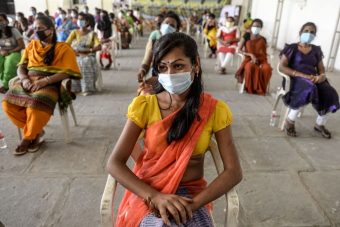 TOPSHOT-INDIA-TRANSGENDER-SOCIAL-HEALTH-VIRUS A group of people sitting outside, well spaced out