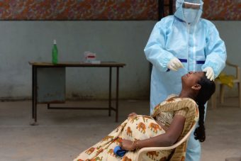 TOPSHOT-INDIA-HEALTH-VIRUS A health worker wearing collects a swab sample of a pregnant woman at a free COVID-19 testing center at Medchal Malkajgiri district on the outskirts of Hyderabad on August 24, 2020. (Photo by NOAH SEELAM/AFP via Getty Images)