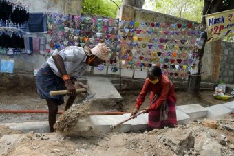 INDIA-HEALTH-VIRUS Laborers work at a road construction site amidst the coronavirus pandemic in Hyderabad, India on April 28, 2021. (Photo by NOAH SEELAM/AFP via Getty Images)